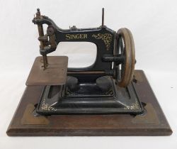A Singer Manufacturing Company model 30K chain stich sewing machine, on a matching cast iron base,
