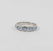 An 18 carat white gold aquamarine and diamond half eternity ring, Sheffield 2003, the four round