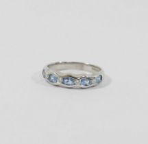 An 18 carat white gold aquamarine and diamond half eternity ring, Sheffield 2003, the four round