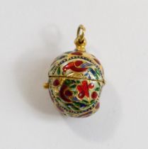 An Indian gold and enamel ovoid pendant, with hinged top, decorated in champleve enamel in white red