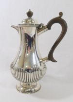 A late Victorian silver hot water jug, Sheffield 1895, of baluster shape with half gadrooned body