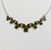 An Edwardian Connemara marble set shamrock necklace, the seven graduated shamrocks with closed