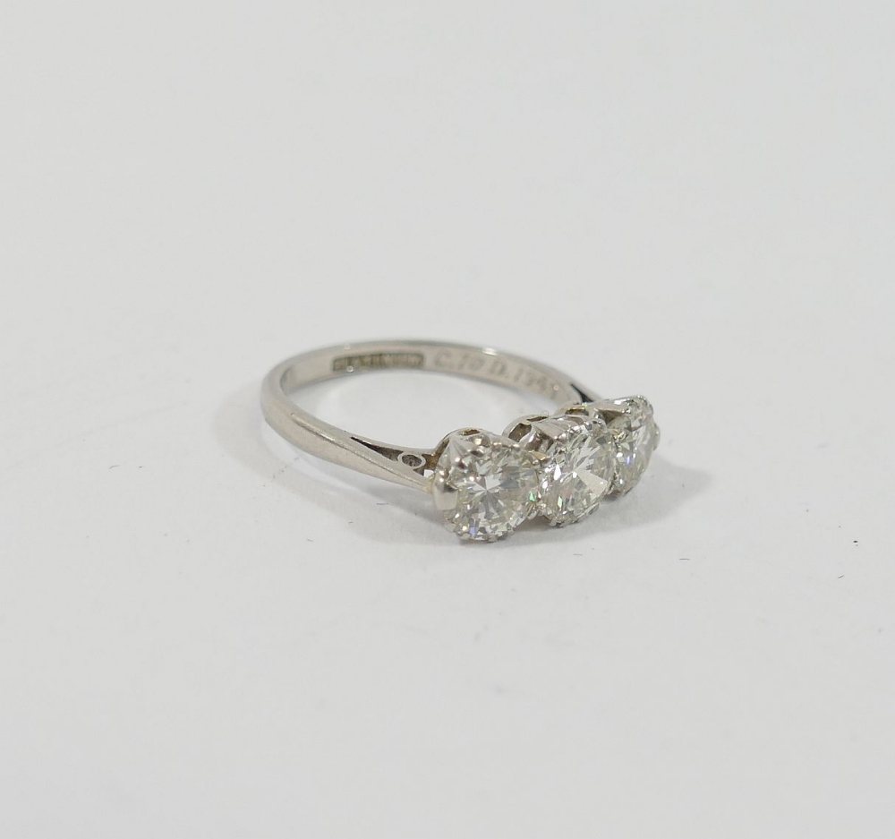 A mid-century platinum and diamond three-stone ring, the round brilliant cut stones combined - Image 4 of 5