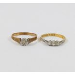 An 18 carat gold diamond three stone ring, the round brilliant cut stones combined weight