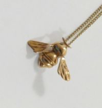 A 9 carat gold bee pendant, London 1983, 2.2cm wide, on chain stamped '9CT', 40.5cm long, combined