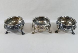 A set of three matched George III circular silver salts, each raised on three hoof feet, with