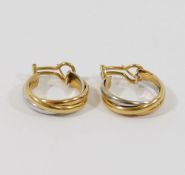 A pair of trinity tri-colour hoop earrings, the clasp stamped '18K', 2.3cm diameter, combined weight