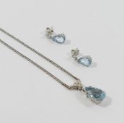 A 9 carat white gold aquamarine and diamond pendant necklace, the pear-shaped mixed-cut aquamarine