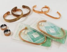 Six hand made copper bangles, and two copper rings, designed to help prevent the wearer from the
