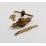 A Victorian brooch set with circular tiger's eye carved in relief with the head of a Centurion,