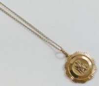 A Georg Jensen 9 carat gold St. Christopher pendant, London 1989, 2.3cm diameter, 5.9g, on a
