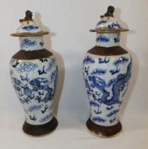 A pair of late 19th century/early 20th century Chinese blue and white crackleware porcelain lidded