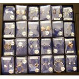 Twenty four pairs of silver and silver coloured metal earrings including studs, hoops and clip-