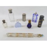 A collection of eight 19th century scent bottles, comprised of a silver topped panelled glass