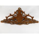 A 19th century Black Forest carved wooden pipe rack, with fern leaf decoration, 37cm wide