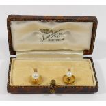 A cultured pearl dress stud, stamped '18CT', and one other smaller similar with indistinct mark,