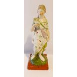 An early 19th century Stafforshire Pearlware figure of Aphrodite holding a dove, 27cm high, a Parian