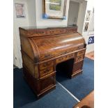 A large Louis XVI style mahogany cylinder bureau fitted with an arrangement of drawers and Pidgeon