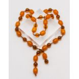 A bead necklace set with a mixture of amber beads, length 36cm.