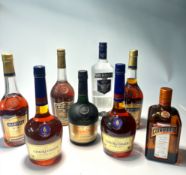 A selection of bottles including Smirnoff triple distilled vodka (1L), Courvoisier VSOP Cognac (