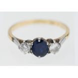 An 18ct platinum and sapphire and diamond set three stone ring