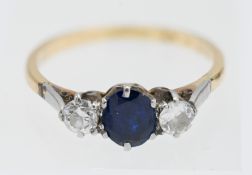 An 18ct platinum and sapphire and diamond set three stone ring