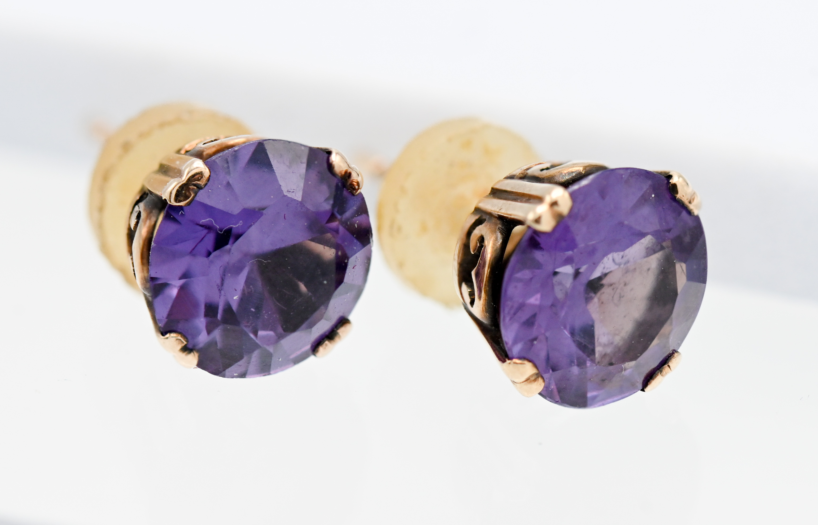 A pair of Alexandrite? and gold stud earrings (unmarked).