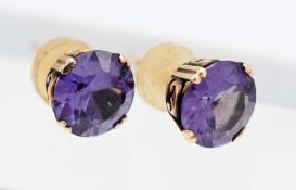 A pair of Alexandrite? and gold stud earrings (unmarked).