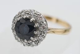 A sapphire and diamond cluster ring, set in 18ct yellow gold, size O.