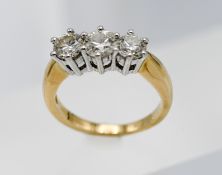 An 18ct yellow gold three stone diamond ring, approx. 1ct in total, size I.