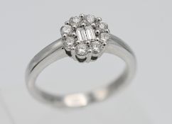 An 18ct white gold diamond cluster ring, size L.