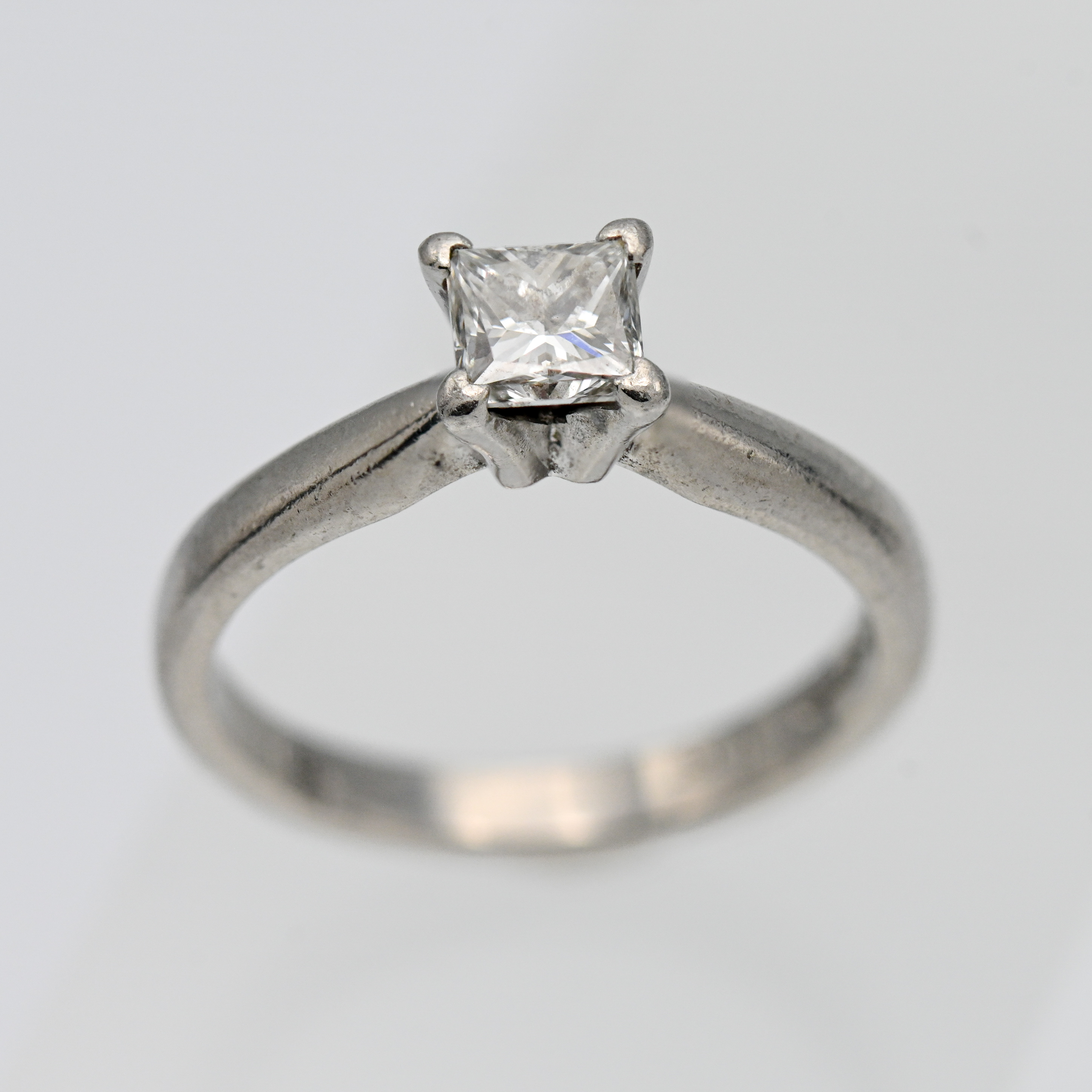 A diamond solitaire engagement ring, princess cut, set in platinum, size M.