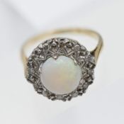 A large opal and diamond cluster ring, set in 18ct yellow gold, size O.