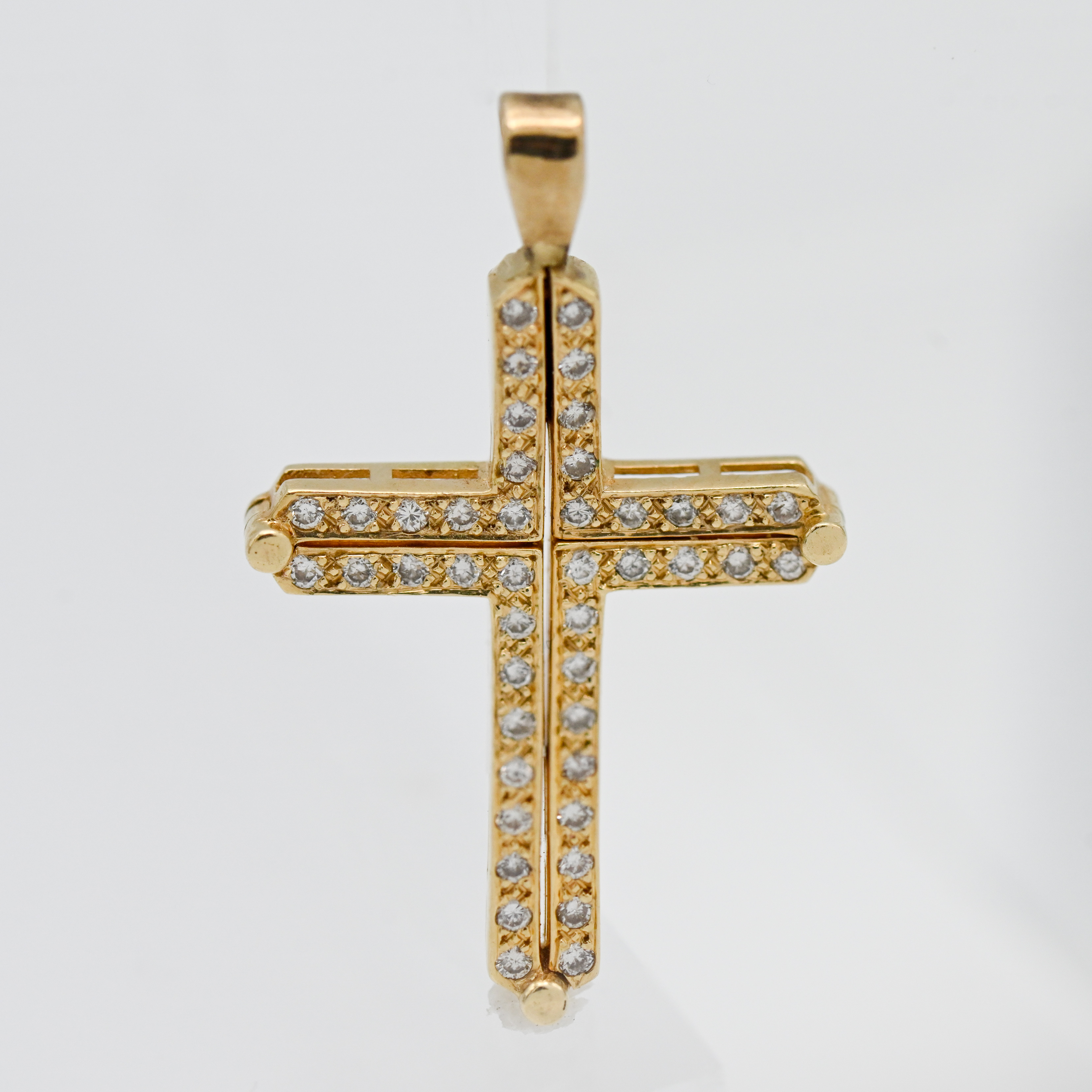 A gold and diamond set cross pendant, 25mm x 20mm.