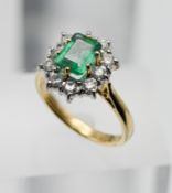 An emerald and diamond cluster ring, set in 18ct yellow gold, size N.