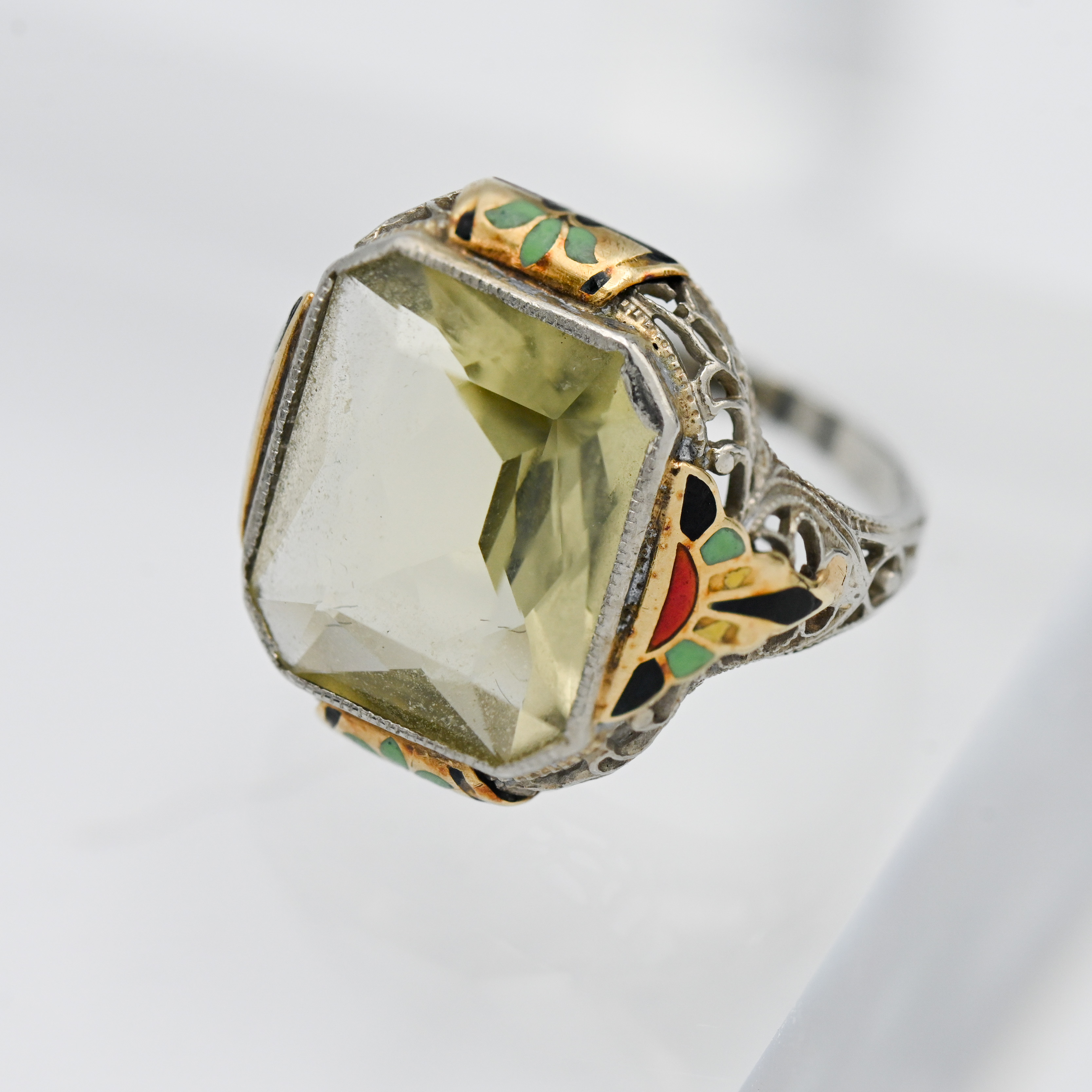 An enamel and gold gem stone ring, size H.