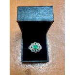 A fine emerald and diamond cluster ring, set in 18ct white gold, makers mark JDT, size R.