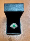 A fine emerald and diamond cluster ring, set in 18ct white gold, makers mark JDT, size R.