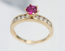 An 18ct yellow gold diamond and ruby ring, size L/M.