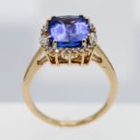 Tanzanite and diamond cluster ring, set in 18ct yellow gold, marked Lorique, size O.