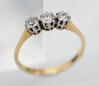 A diamond three stone ring, set in 18ct yellow gold, size M.