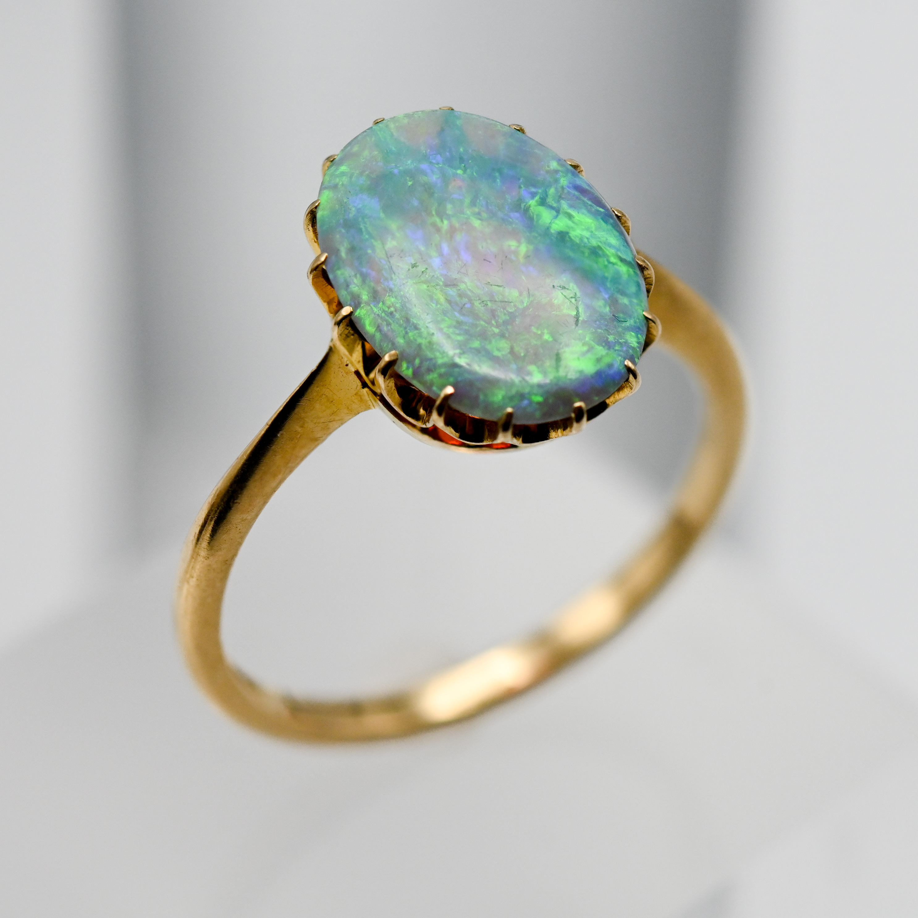 A large oval shape opal, set in 18ct yellow gold, size P.