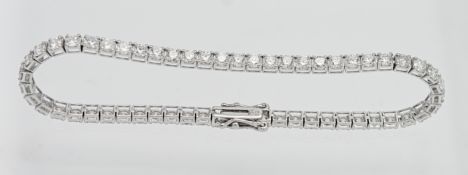 A diamond line bracelet set with fifty six diamonds approx. 5.6ct, set in 18k white gold, length