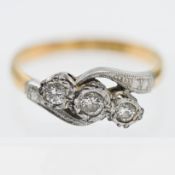 A diamond three stone cross over ring, set in 18ct yellow gold stamped LEB & S, size K.