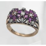 An 18ct ruby and diamond flower cluster ring, size L/M (not hallmarked).
