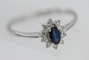 9ct white gold oval cut sapphire ring surrounded by 10 brilliant cut diamonds with 9ct white gold