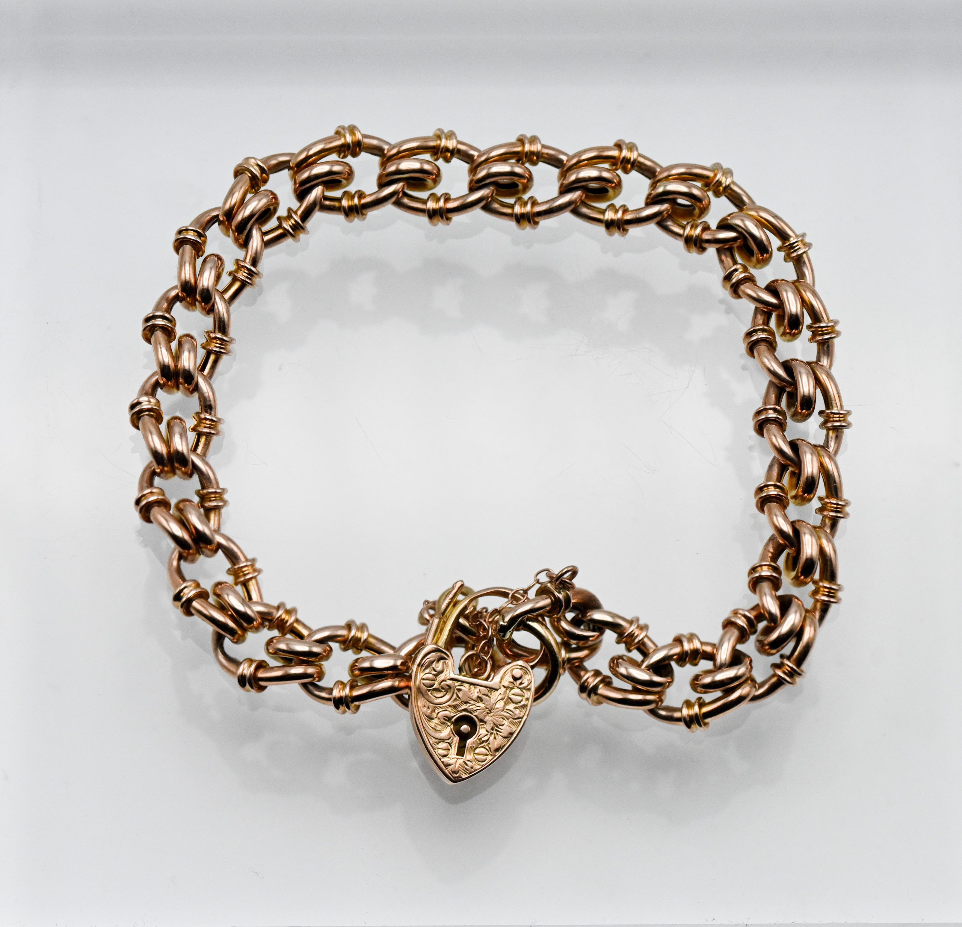 A 9ct rose gold fancy curb link bracelet, fancy open curb link with ribbed sides