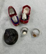 Two cased silver thimbles together with two silver rings and a brooch depicting a lady.