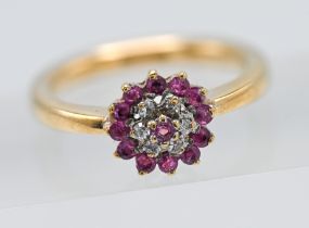 18ct ruby & diamond round shaped cluster ring. Central ruby surrounded by six round cut diamonds