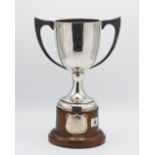 A George V silver cup on wooden stand, Birmingham hallmark, letter D, 1928-1929, approx. 17.32oz.